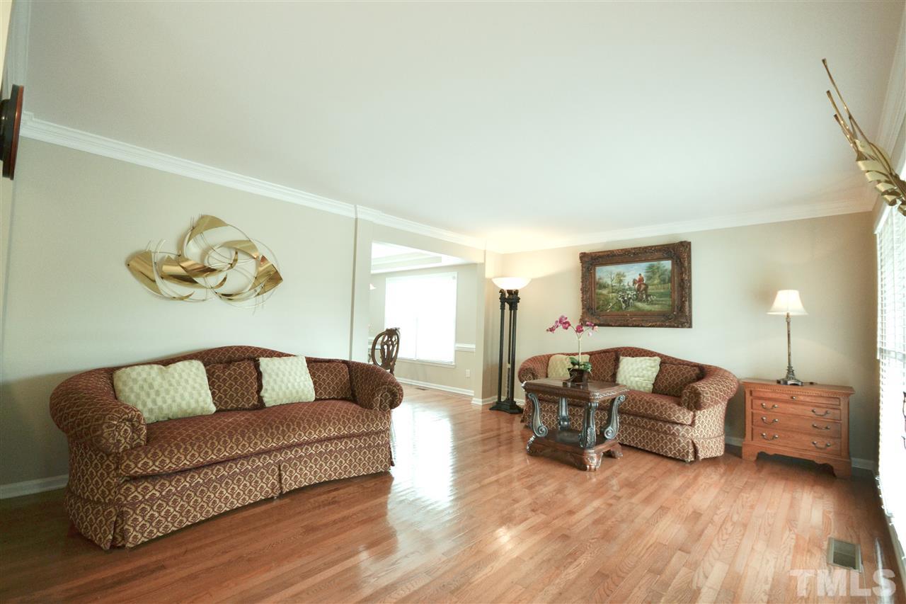 2341 Kendricks Court Raleigh, NC 27613 - Photo 5 of 29 a living room with furniture and a wooden floor