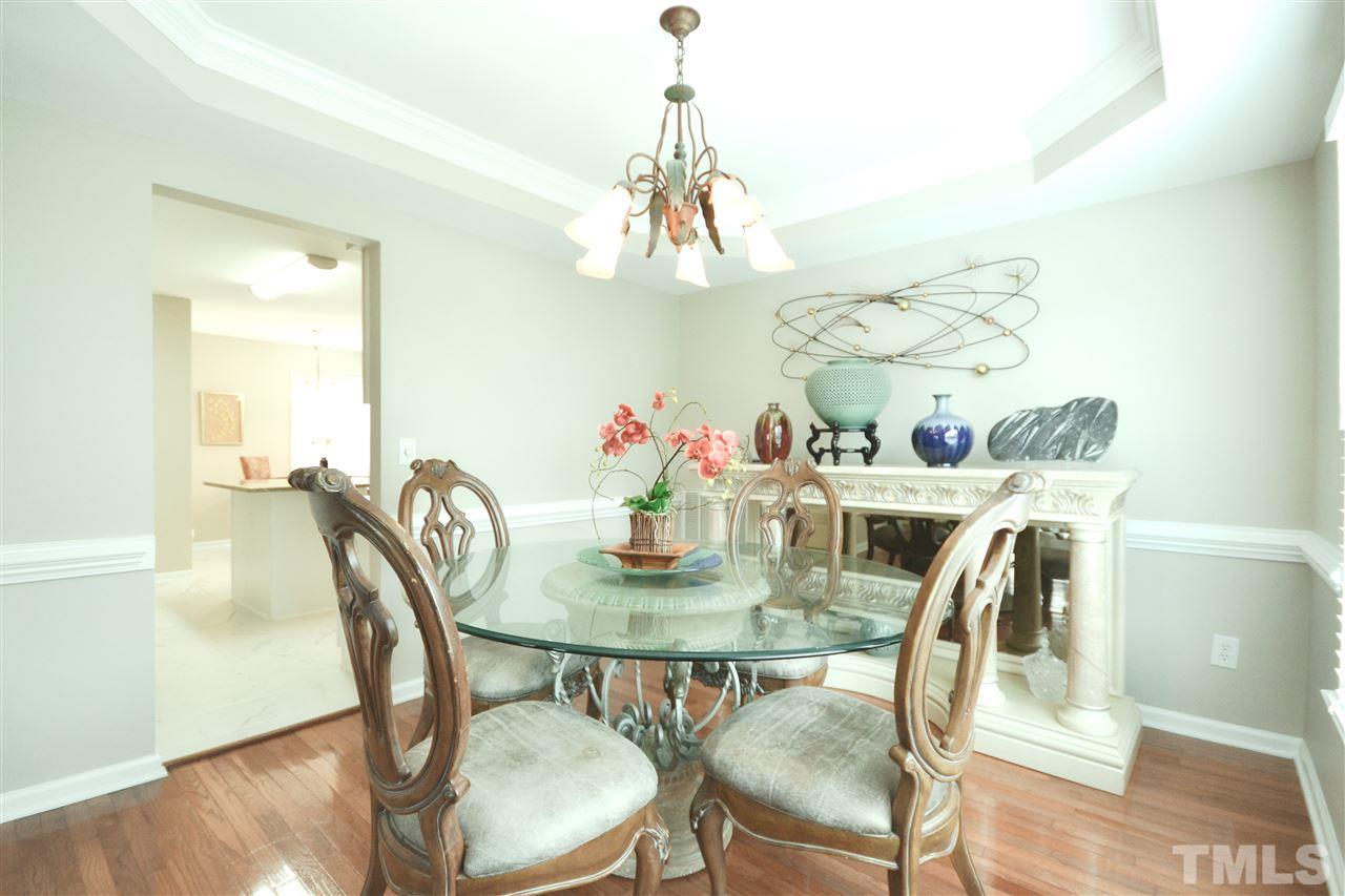 2341 Kendricks Court Raleigh, NC 27613 - Photo 9 of 29 a view of a dining room with furniture a chandelier and wooden floor