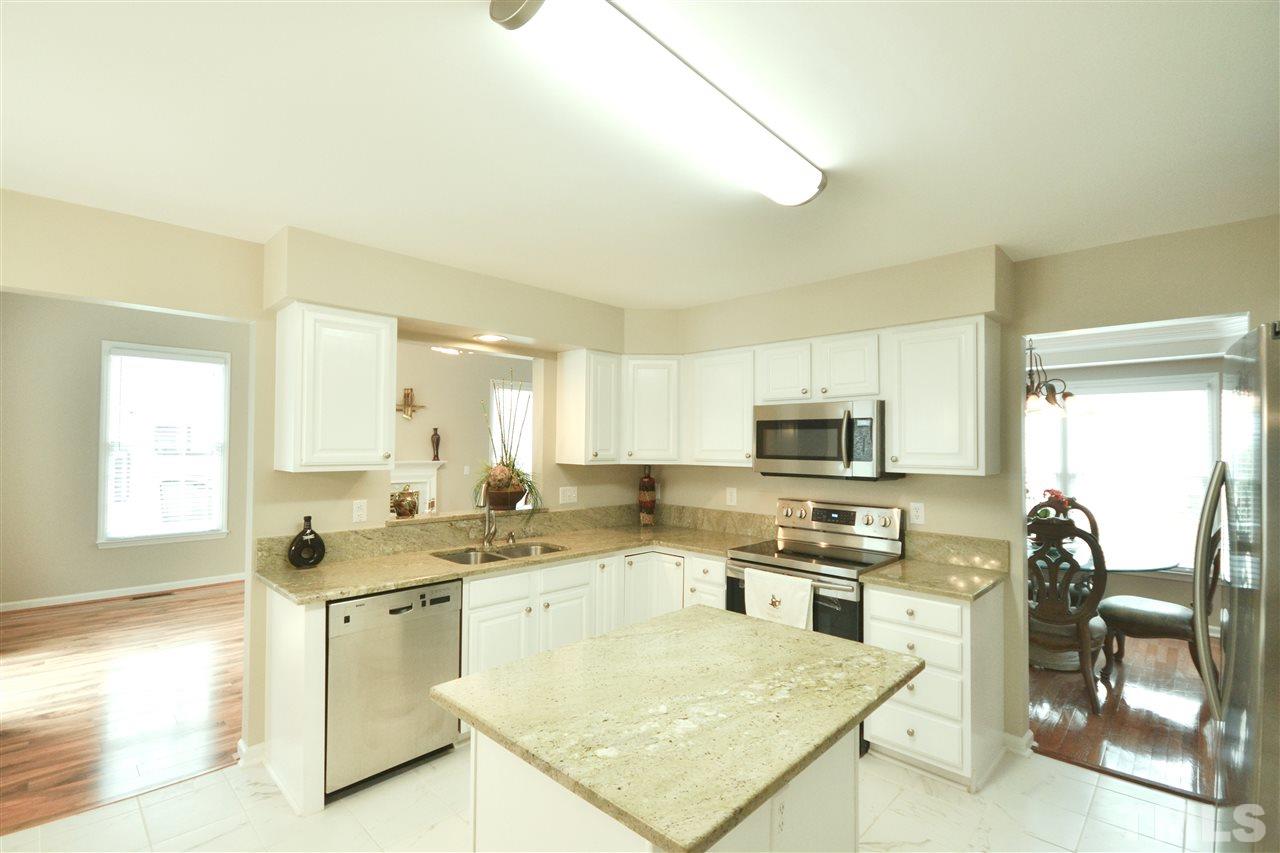 2341 Kendricks Court Raleigh, NC 27613 - Photo 10 of 29 a kitchen with a stove a sink and a refrigerator
