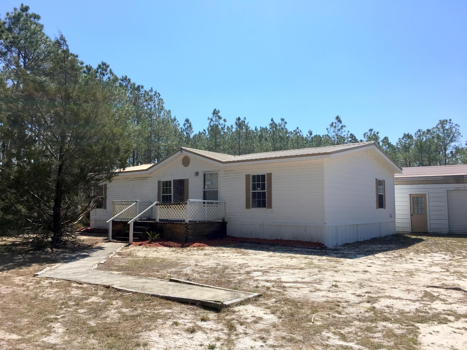 882 Don Graff Road Freeport, FL 32439 - Photo 1 of 22 a house with trees in the background
