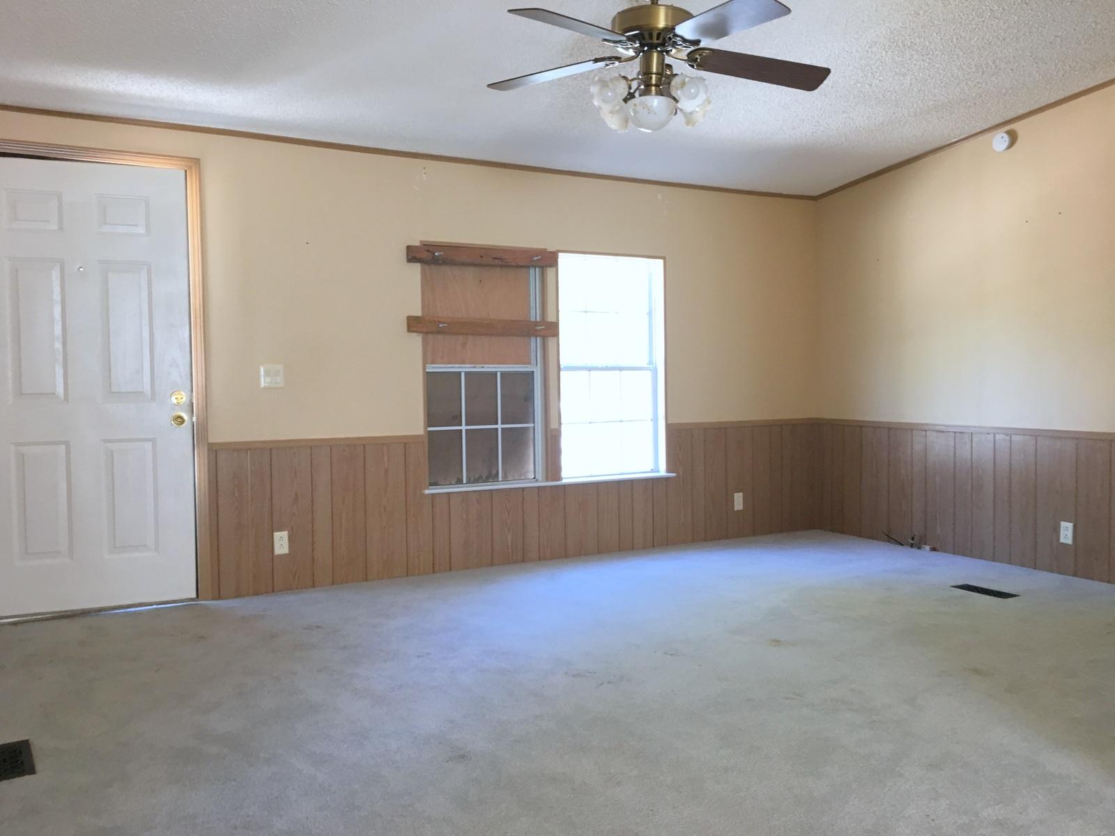 882 Don Graff Road Freeport, FL 32439 - Photo 2 of 22 an empty room with windows and fan