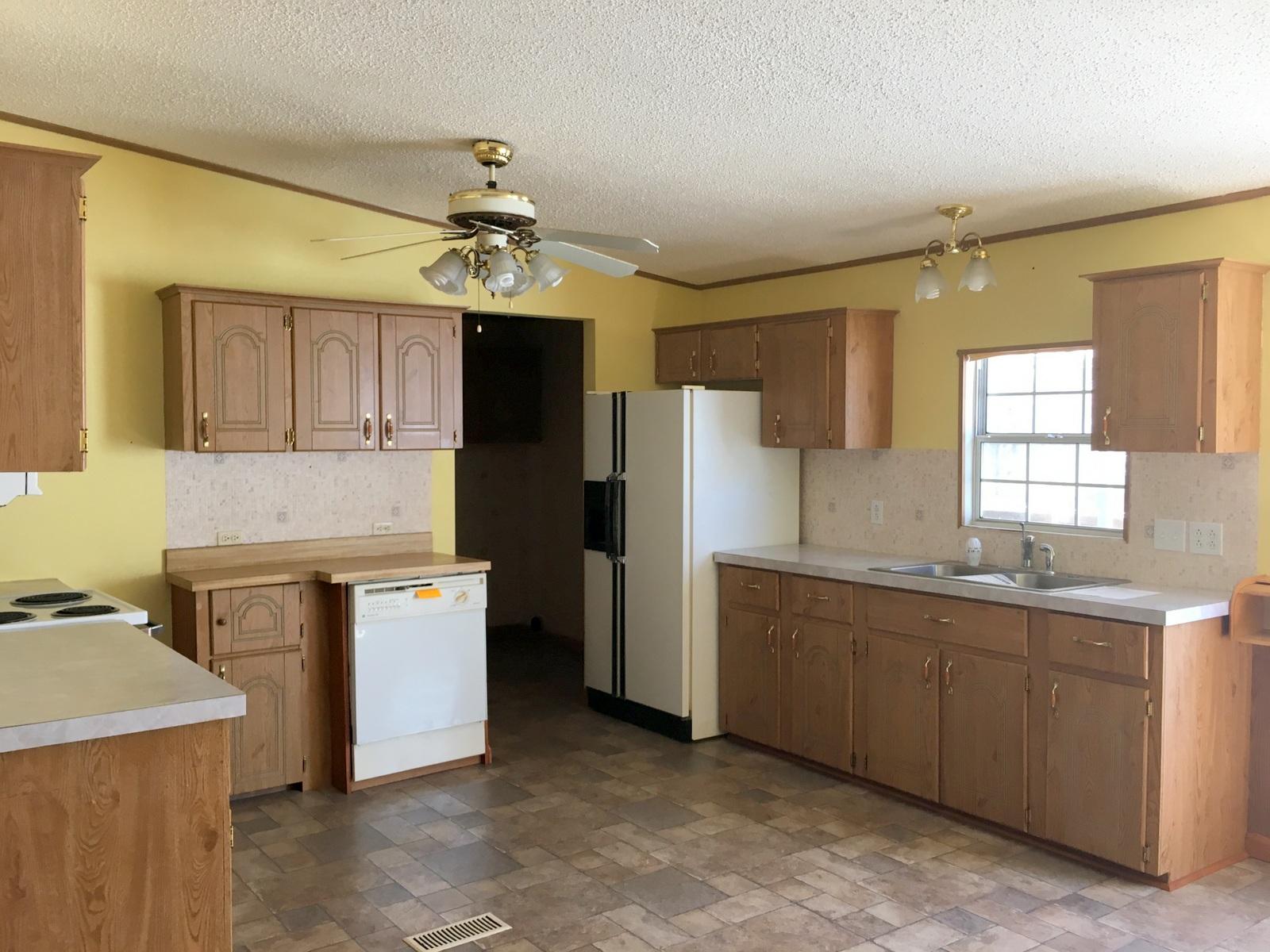882 Don Graff Road Freeport, FL 32439 - Photo 3 of 22 a kitchen with a sink appliances and cabinets