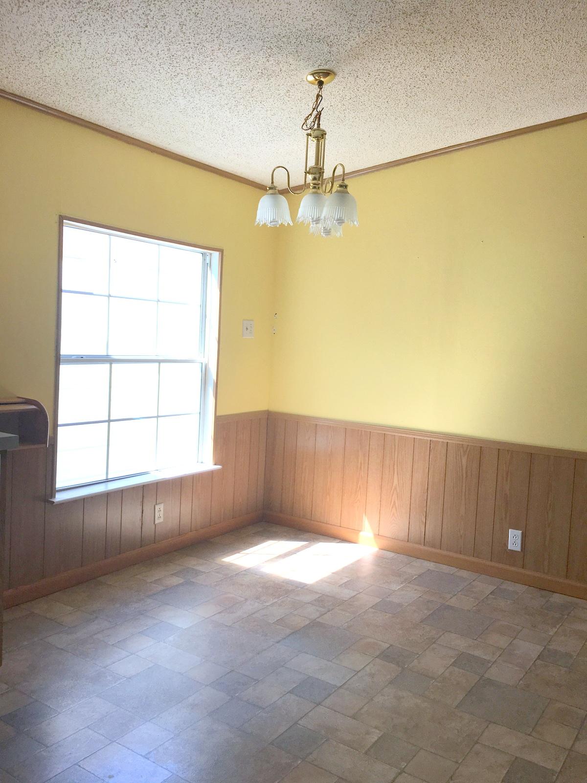 882 Don Graff Road Freeport, FL 32439 - Photo 5 of 22 en empty room with windows and chandelier fan
