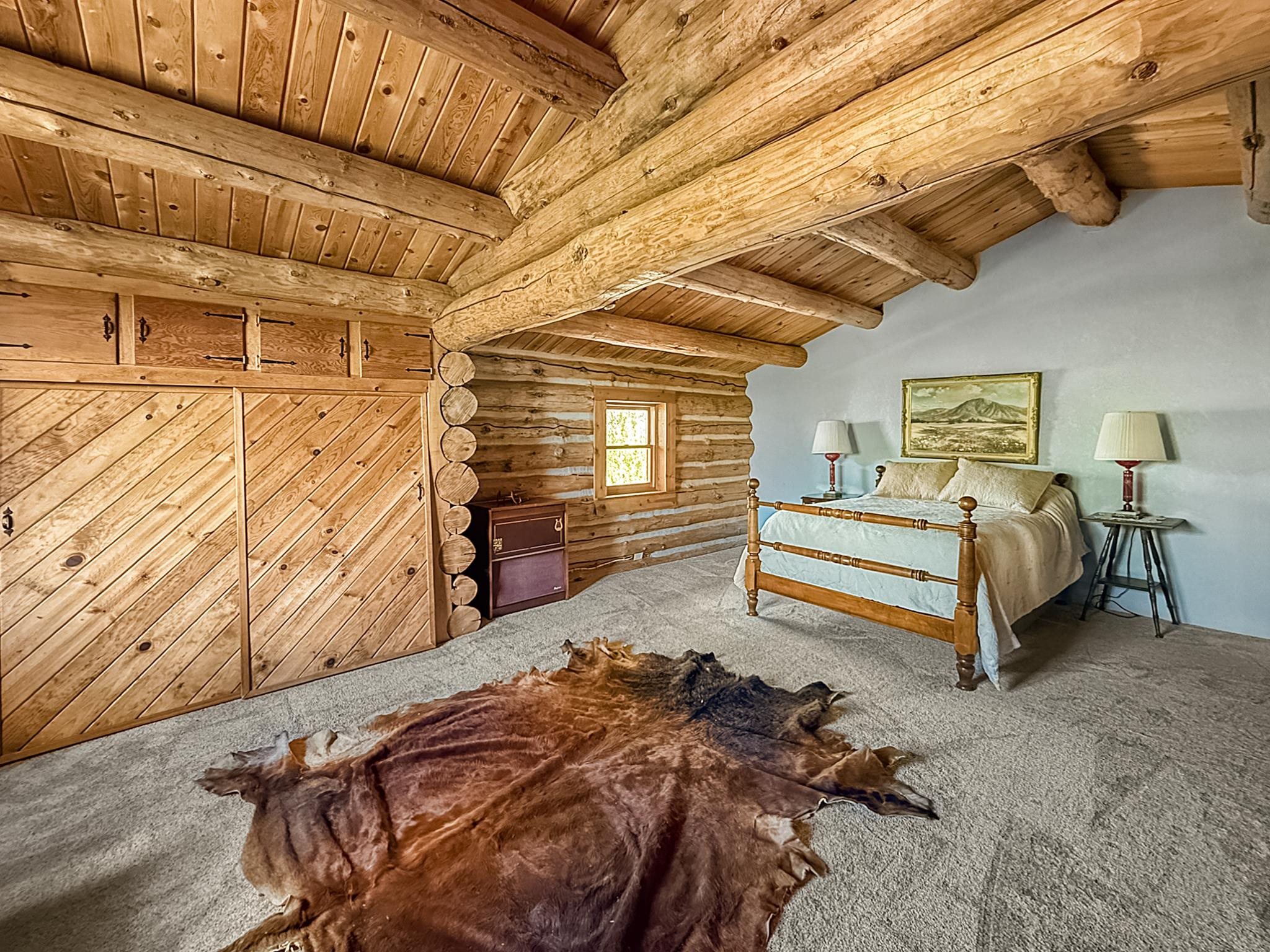 9709 3605 Road Hotchkiss, CO 81419 - Photo 38 of 42 a bed room with a bed and a walk in closet