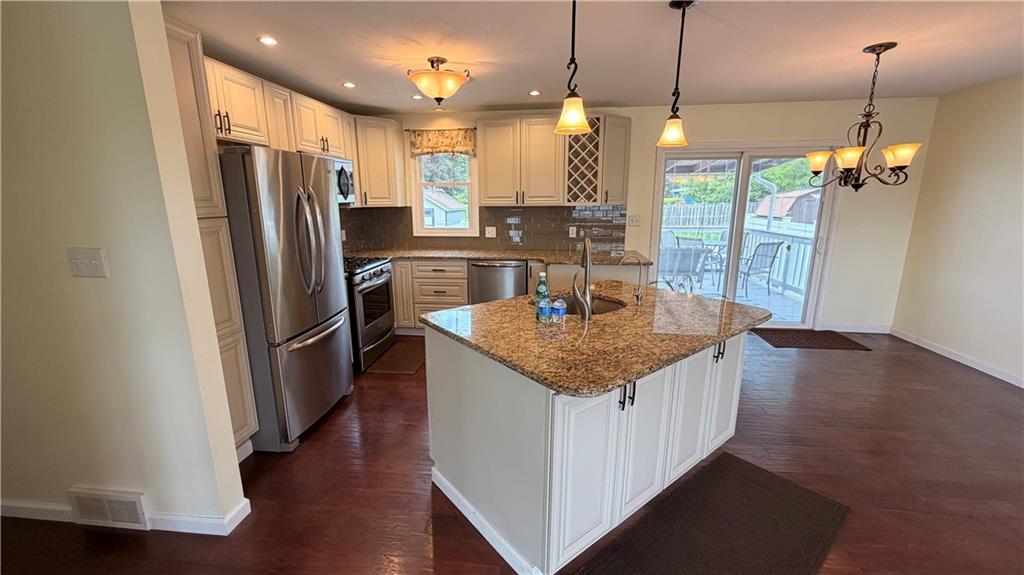 1403 2nd Avenue Beaver, PA 15009 - Photo 4 of 17 a kitchen with stainless steel appliances granite countertop a refrigerator a sink a stove and a wooden floor