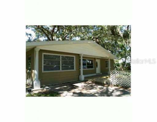 7833 Chasco Street Port Richey, FL 34668 - Photo 1 of 1 a front view of a house with a yard