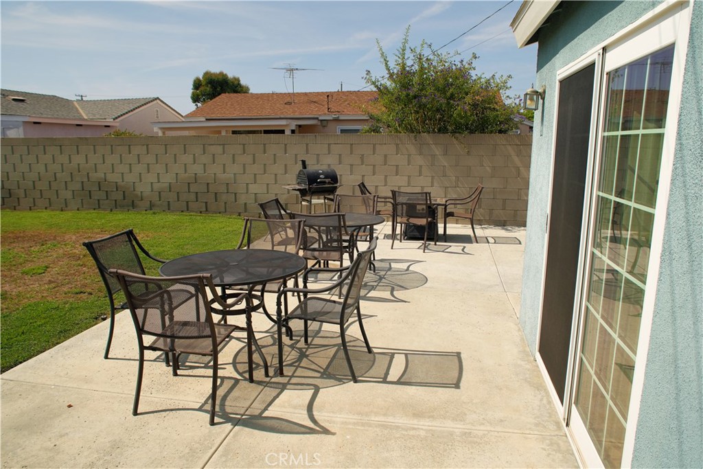 6431 Cathay Circle Buena Park, CA 90620 - Photo 16 of 65 a view of a patio with table and chairs with wooden floor and fence