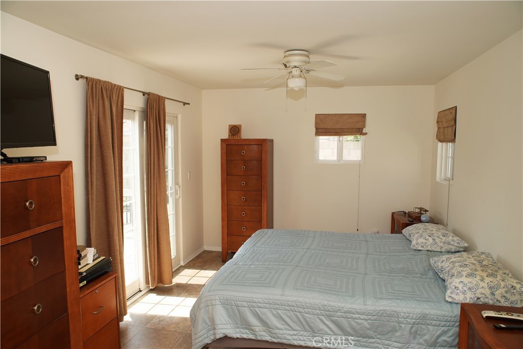 6431 Cathay Circle Buena Park, CA 90620 - Photo 33 of 65 a bedroom with a large bed and flat tv screen on dresser