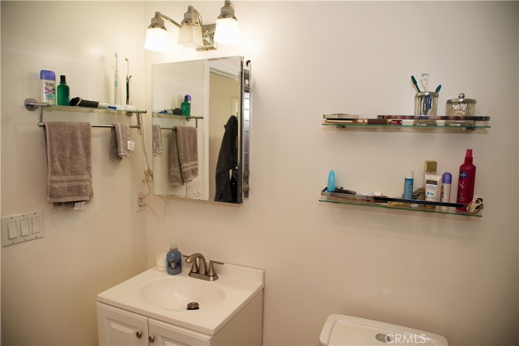 6431 Cathay Circle Buena Park, CA 90620 - Photo 38 of 65 a bathroom with a sink a mirror and vanity