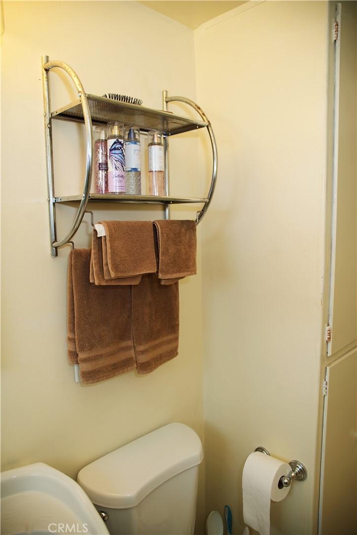 6431 Cathay Circle Buena Park, CA 90620 - Photo 48 of 65 a bathroom with a toilet and a mirror