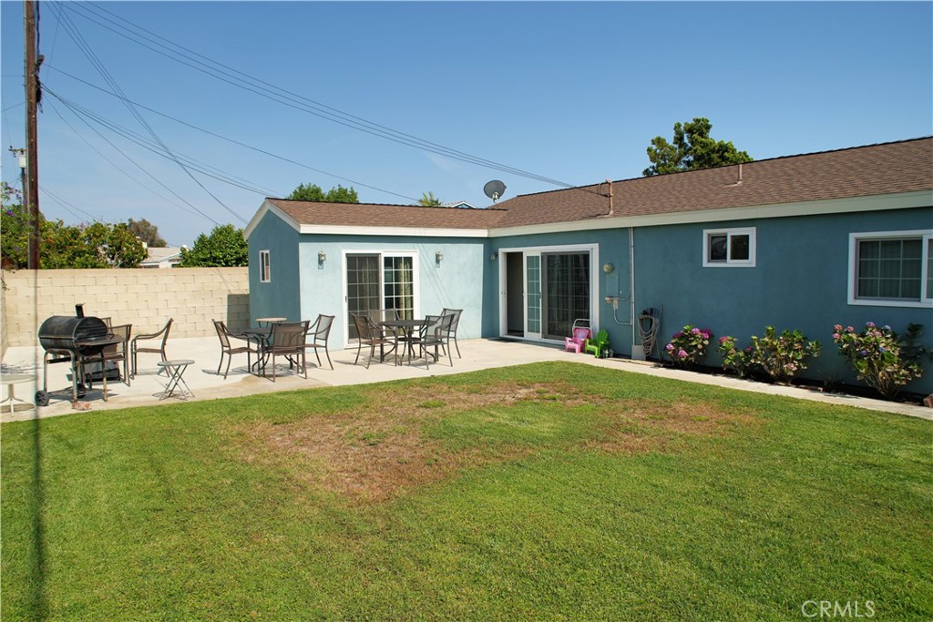 6431 Cathay Circle Buena Park, CA 90620 - Photo 9 of 65 View from left side of backyard, Left side sliding door leads to the primary suite. The right side door leads to the dining area.