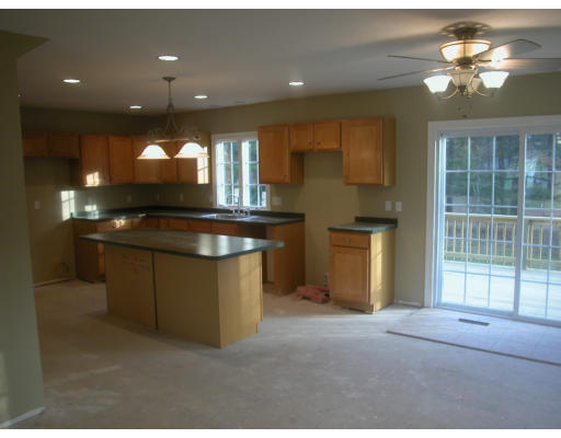 668 County Road Wareham, MA 02576 - Photo 6 of 7 a kitchen with kitchen island a sink stainless steel appliances and cabinets
