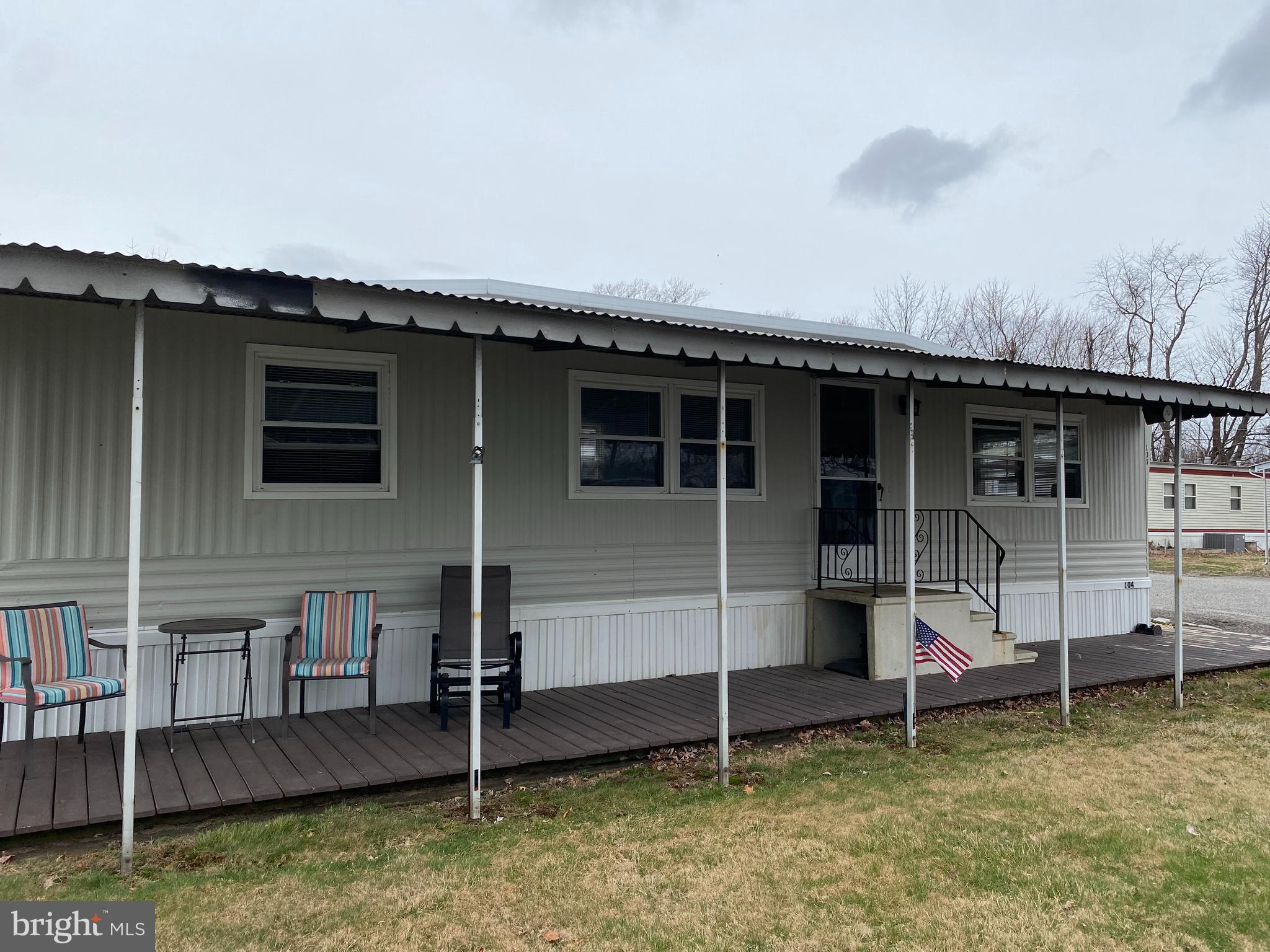 46 Jones Mill Road, Unit 104 Wrightstown, NJ 08562 - Photo 1 of 11 a backyard of a house with barbeque oven and table