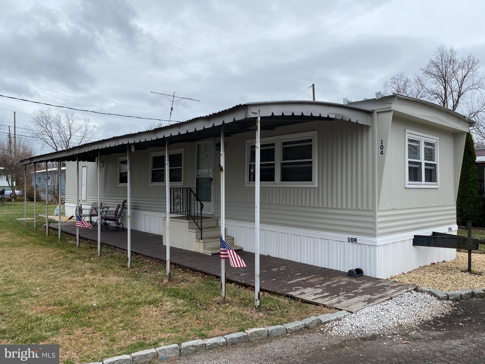 46 Jones Mill Road, Unit 104 Wrightstown, NJ 08562 - Photo 2 of 11 a view of a house with a patio and a yard