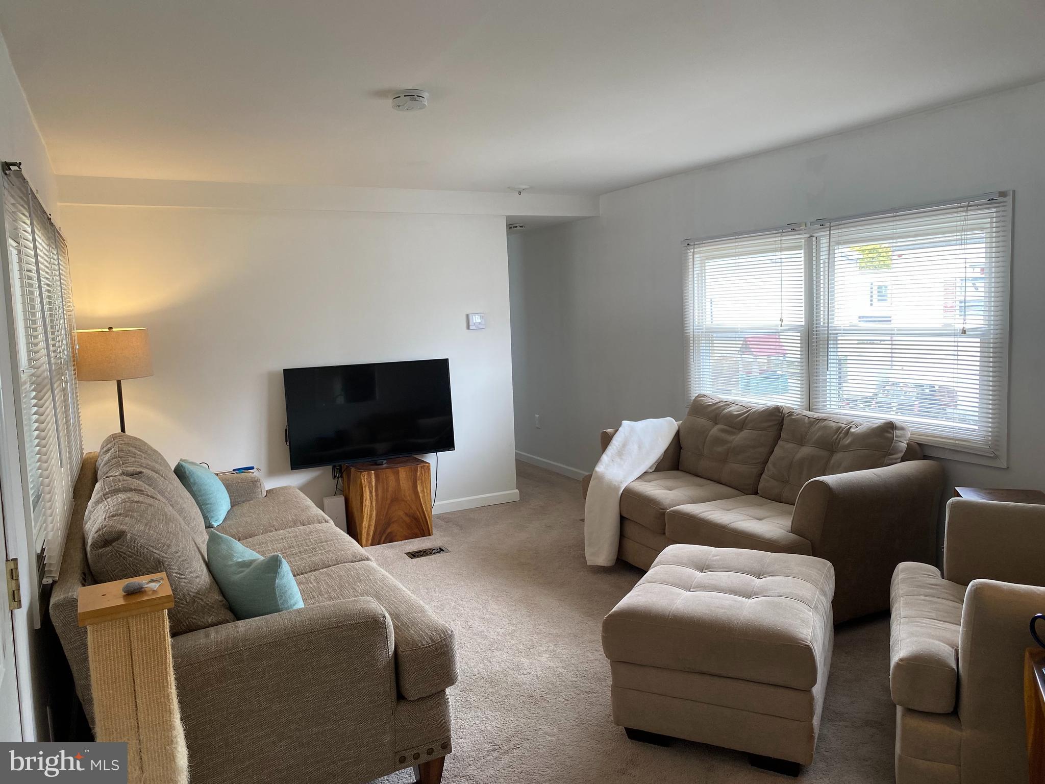 46 Jones Mill Road, Unit 104 Wrightstown, NJ 08562 - Photo 3 of 11 a living room with furniture and a flat screen tv