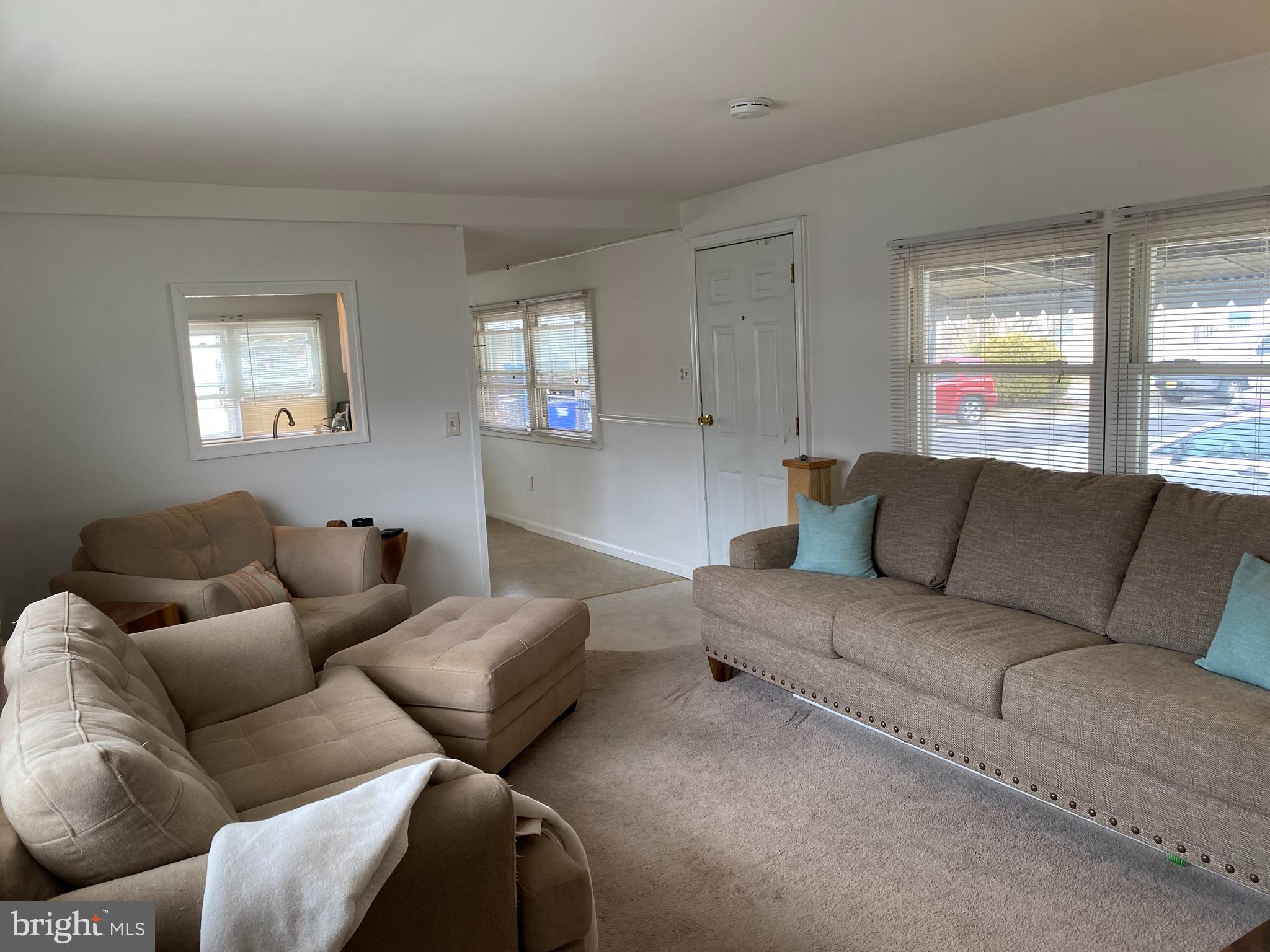 46 Jones Mill Road, Unit 104 Wrightstown, NJ 08562 - Photo 4 of 11 a living room with furniture and a large window