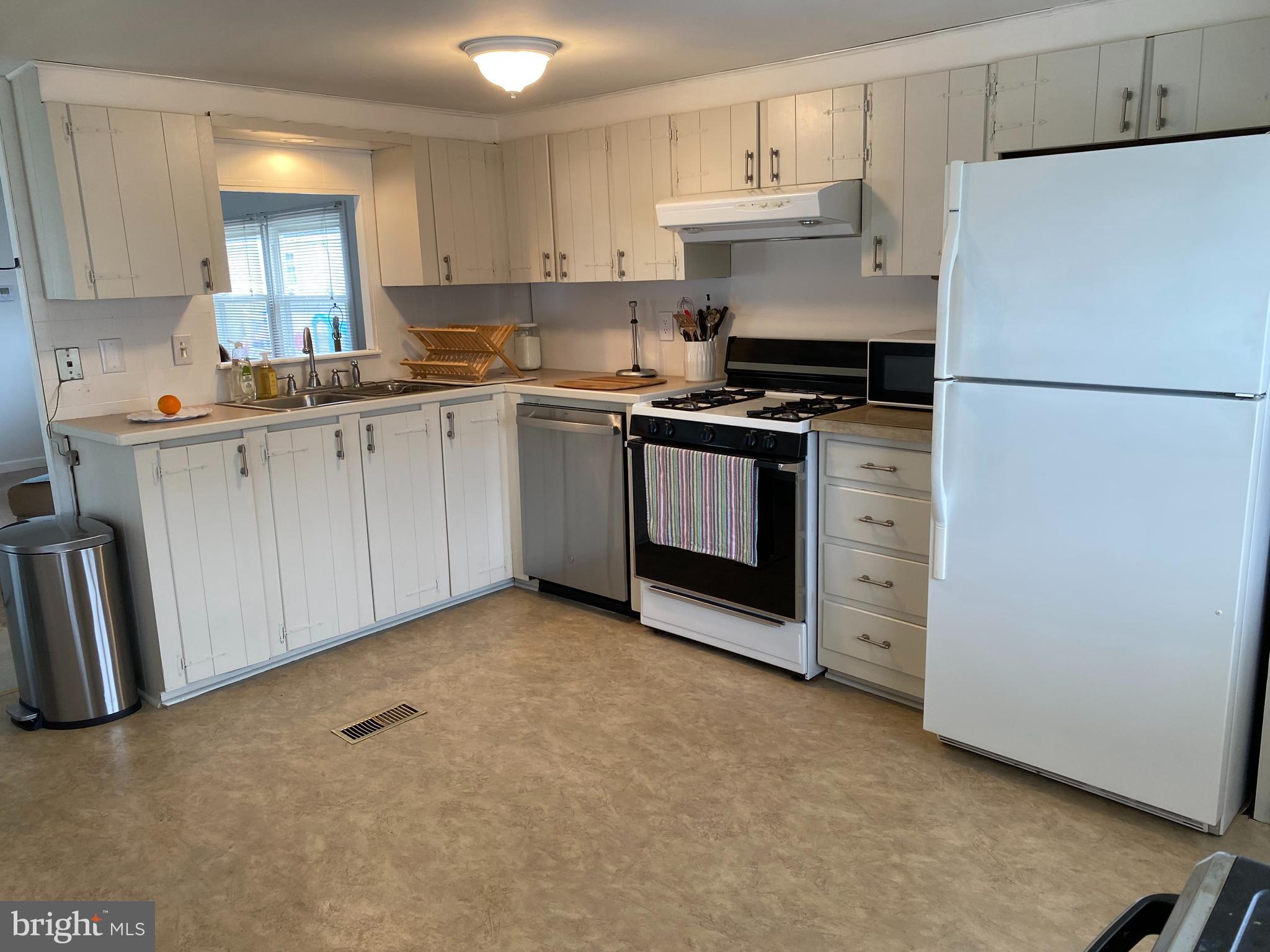 46 Jones Mill Road, Unit 104 Wrightstown, NJ 08562 - Photo 6 of 11 a kitchen with a refrigerator stove and white cabinets