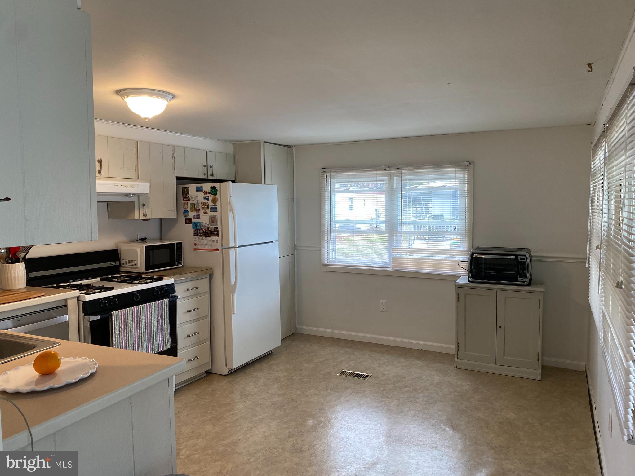 46 Jones Mill Road, Unit 104 Wrightstown, NJ 08562 - Photo 7 of 11 a kitchen with stainless steel appliances granite countertop a refrigerator a stove a sink and a refrigerator