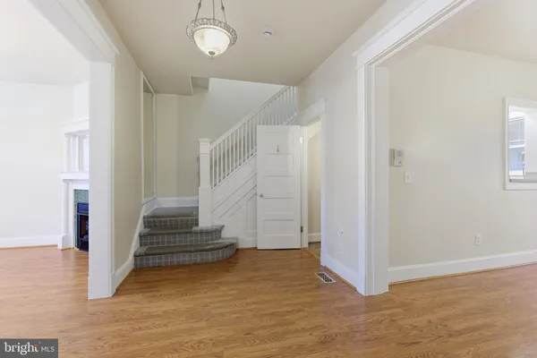 a view of entryway with wooden floor and stair