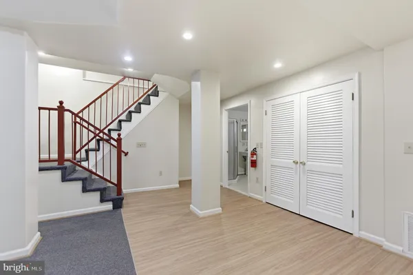 a view of entryway with wooden floor and stairs