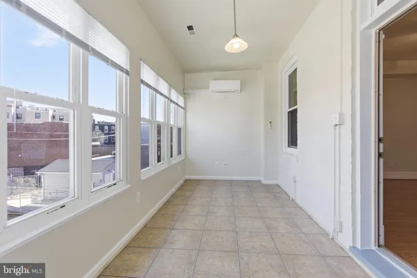 a kitchen with stainless steel appliances white cabinets and a refrigerator