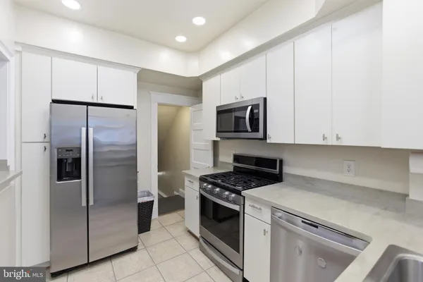 a kitchen with refrigerator and cabinets