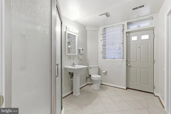 a bathroom with a toilet sink and shower