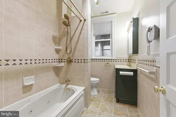 a bathroom with a sink a toilet and mirror