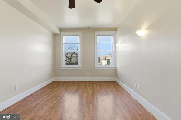 wooden floor in an empty room with a window