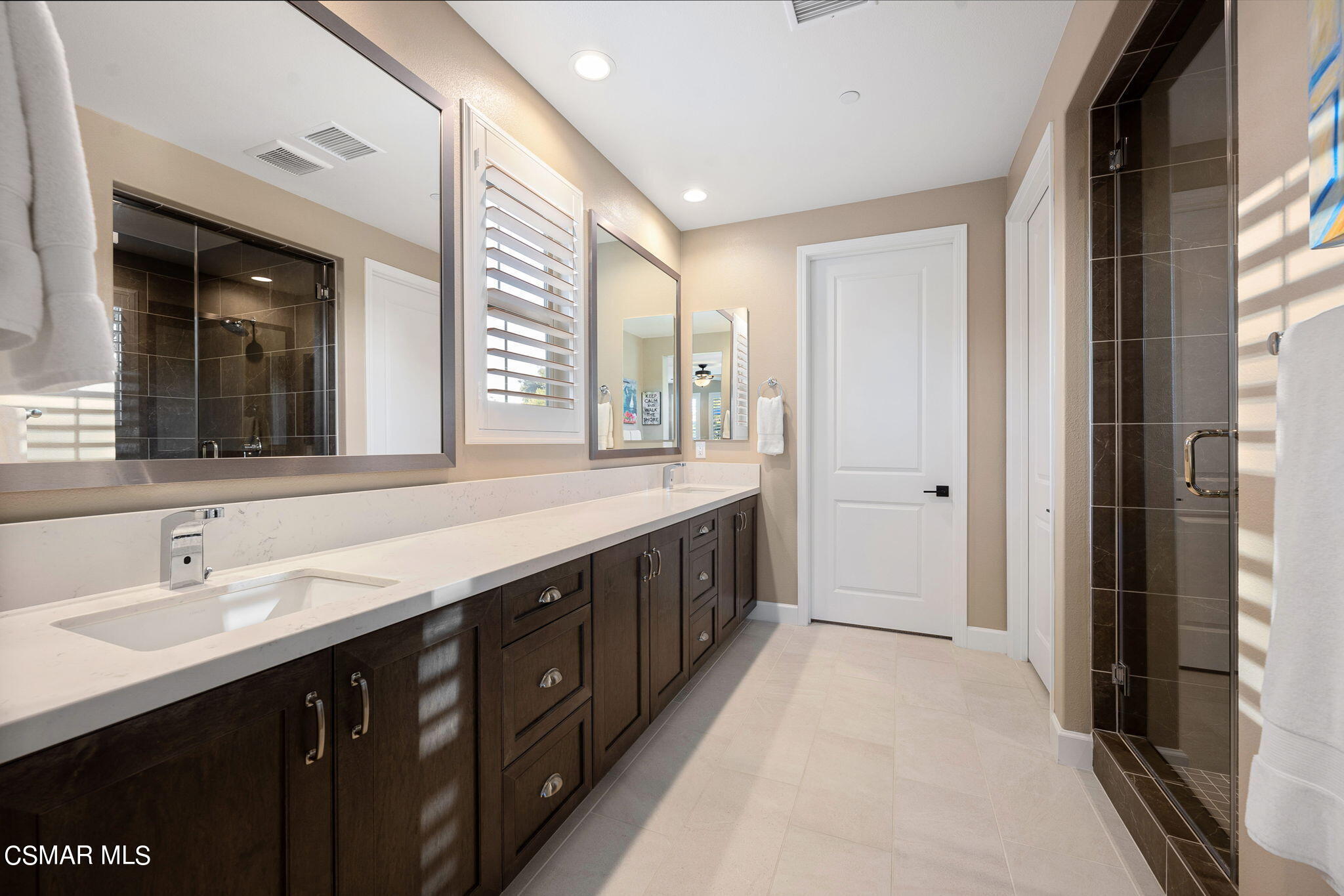 2392 Rondell Road Camarillo, CA 93012 - Photo 38 of 81 a spacious bathroom with a double vanity sink and a mirror