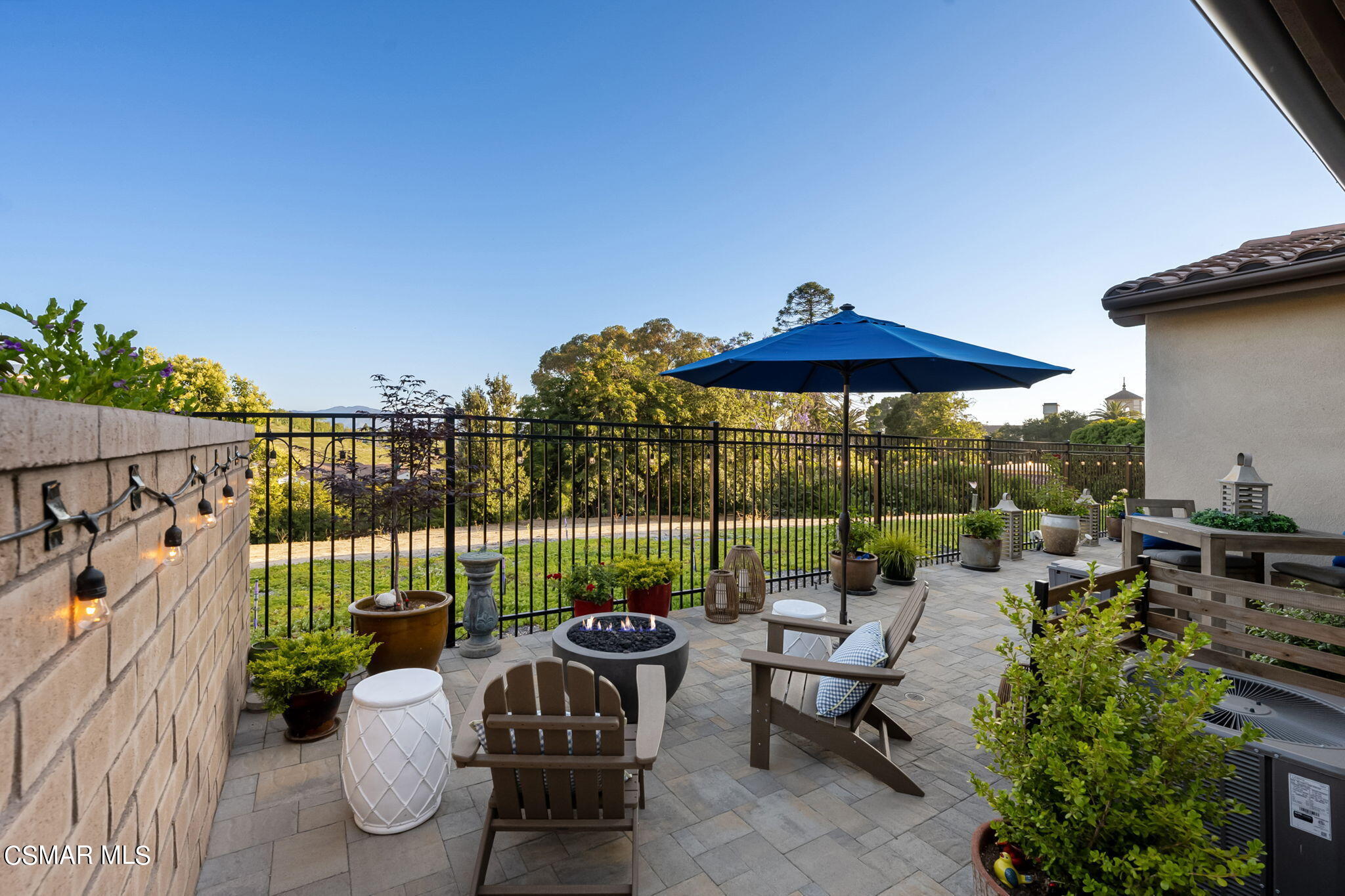 2392 Rondell Road Camarillo, CA 93012 - Photo 6 of 81 a view of a patio with couches chairs potted plants and a palm tree
