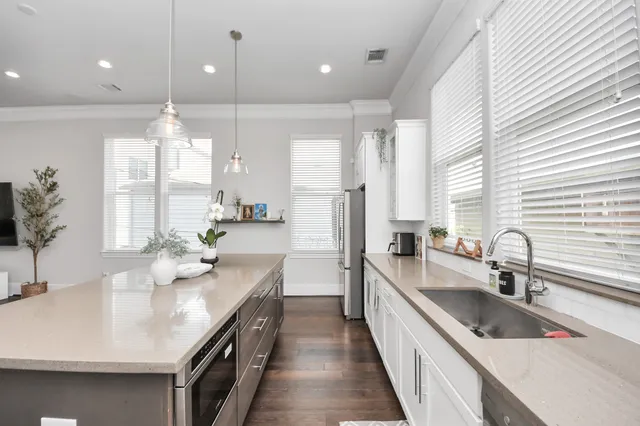 a kitchen with stainless steel appliances a sink stove and cabinets
