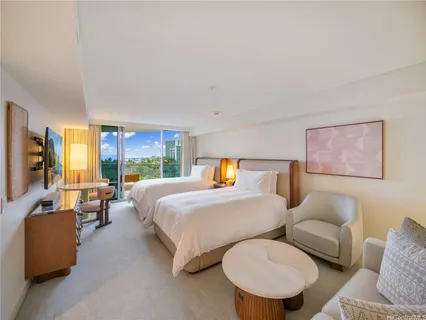 a bedroom with furniture and a large window