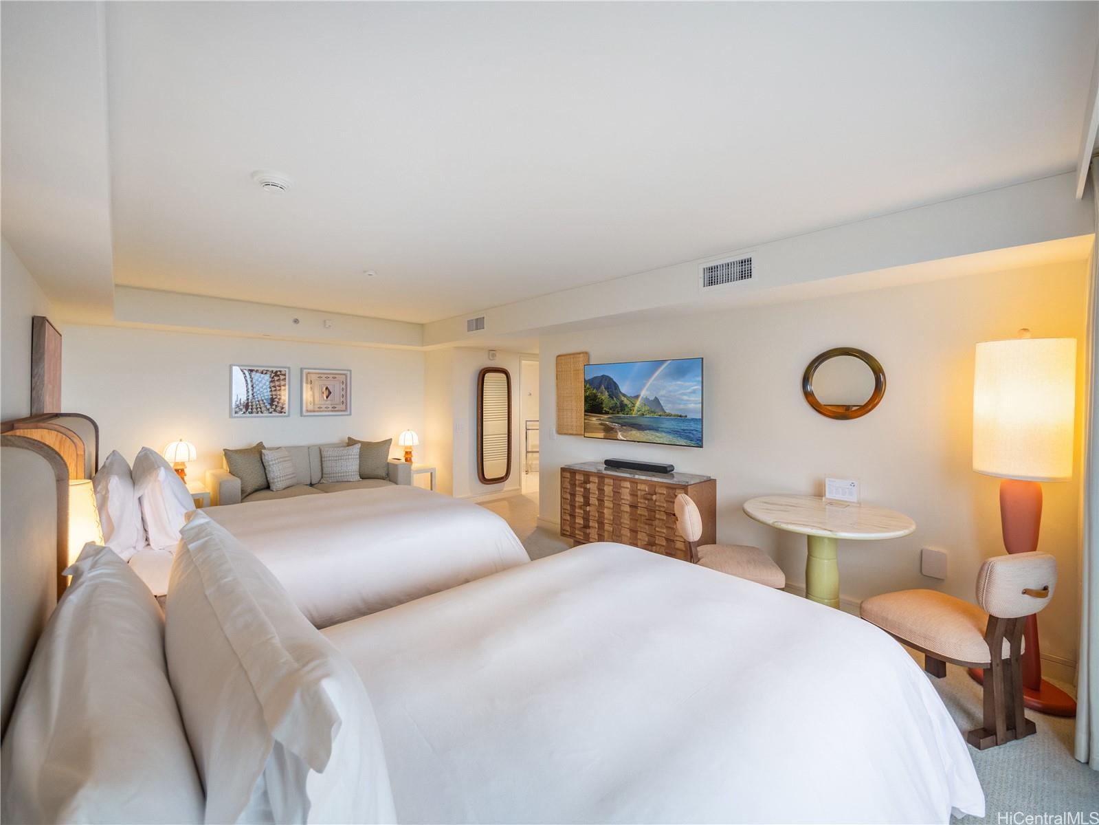 223 Saratoga Road, Unit 1105 Honolulu, HI 96815 - Photo 3 of 14 a bedroom with a bed and lamp