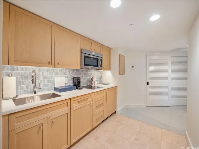 a kitchen with granite countertop white cabinets and stainless steel appliances