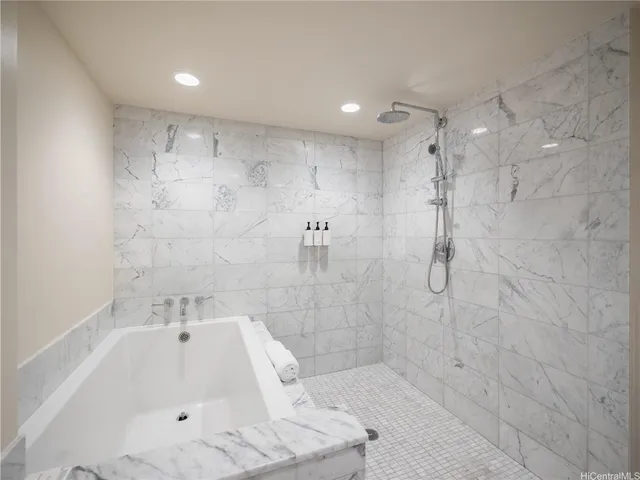 a bathroom with a bathtub and shower