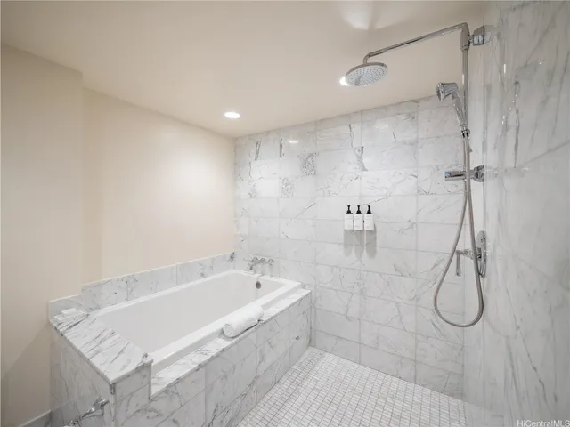 a bathroom with a bathtub and shower