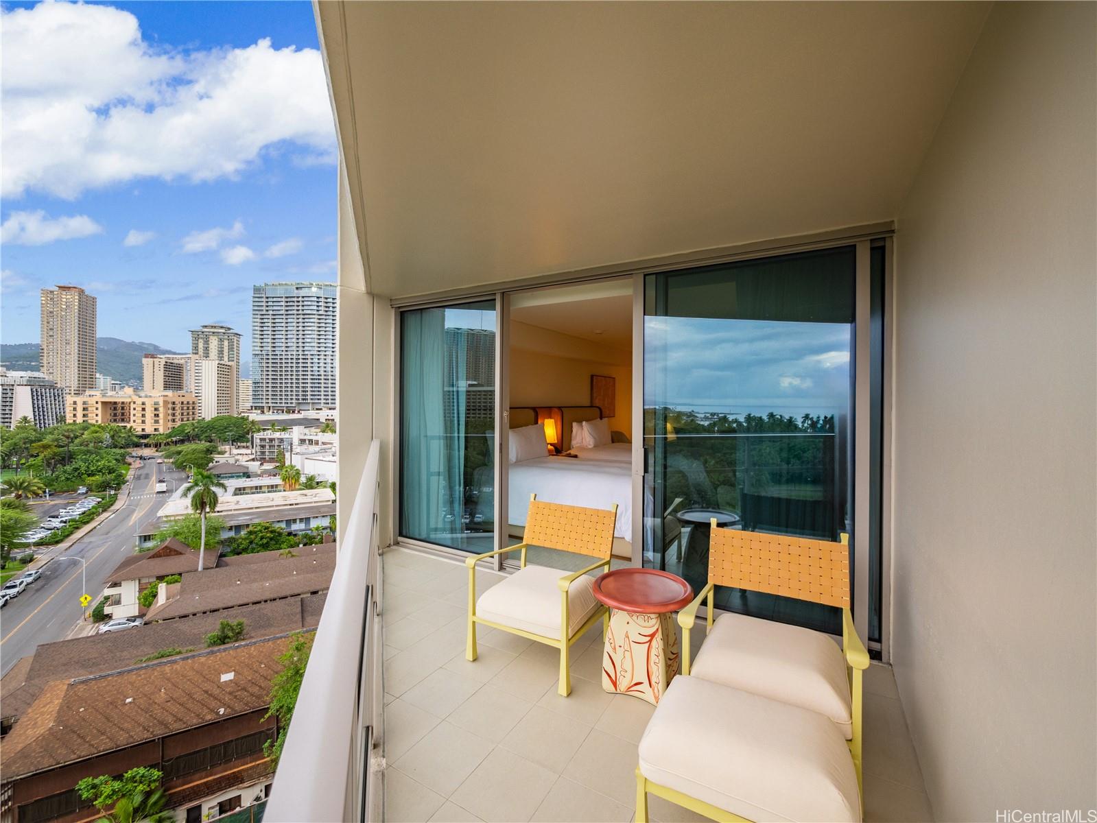 223 Saratoga Road, Unit 1105 Honolulu, HI 96815 - Photo 9 of 14 a view of a balcony with dining table and chairs