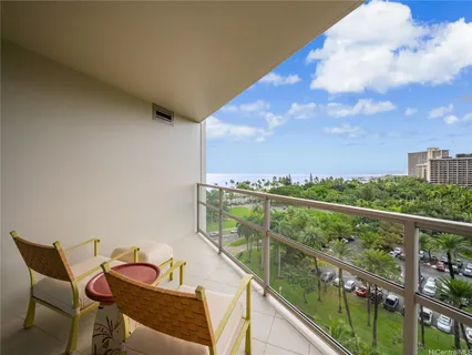 a view of a chairs and table in the balcony
