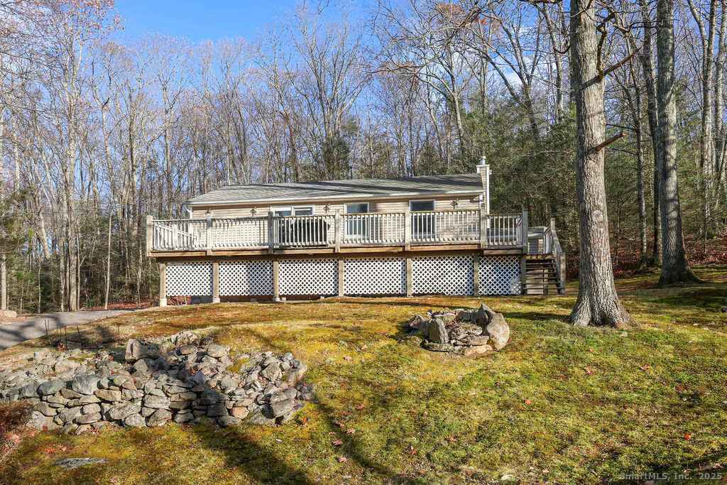 a view of a house with a large tree and a yard