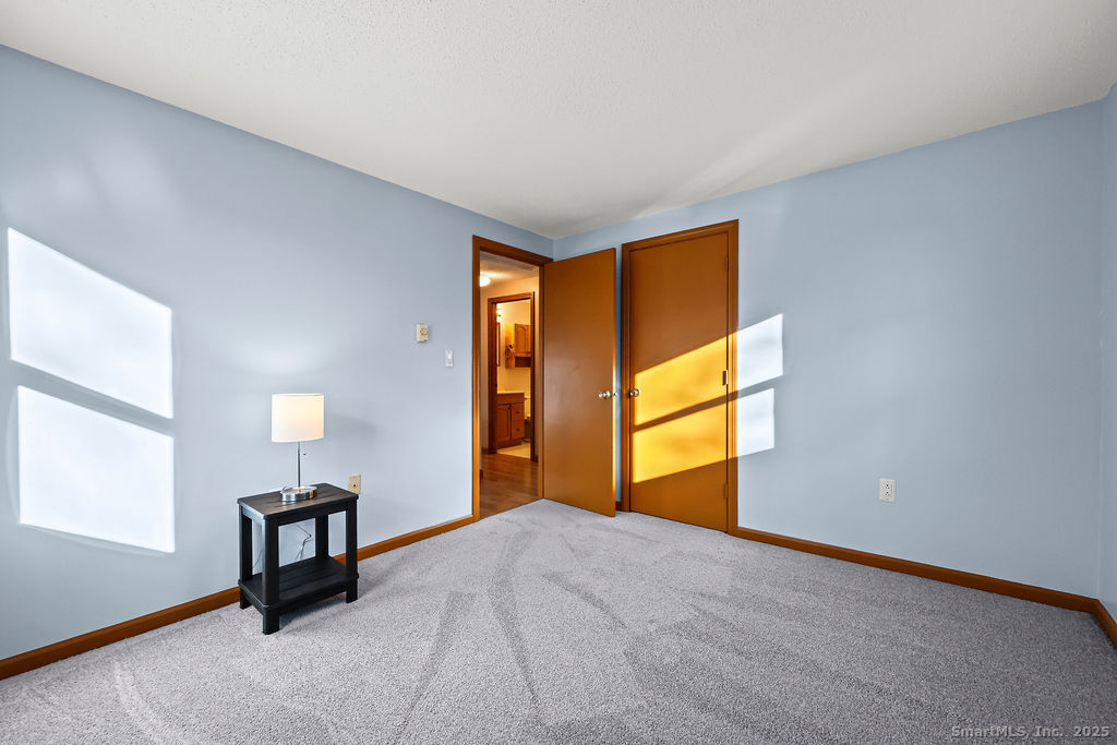 15 Deepwood Road Stafford, CT 06076 - Photo 20 of 30 a bedroom with a bed and a window