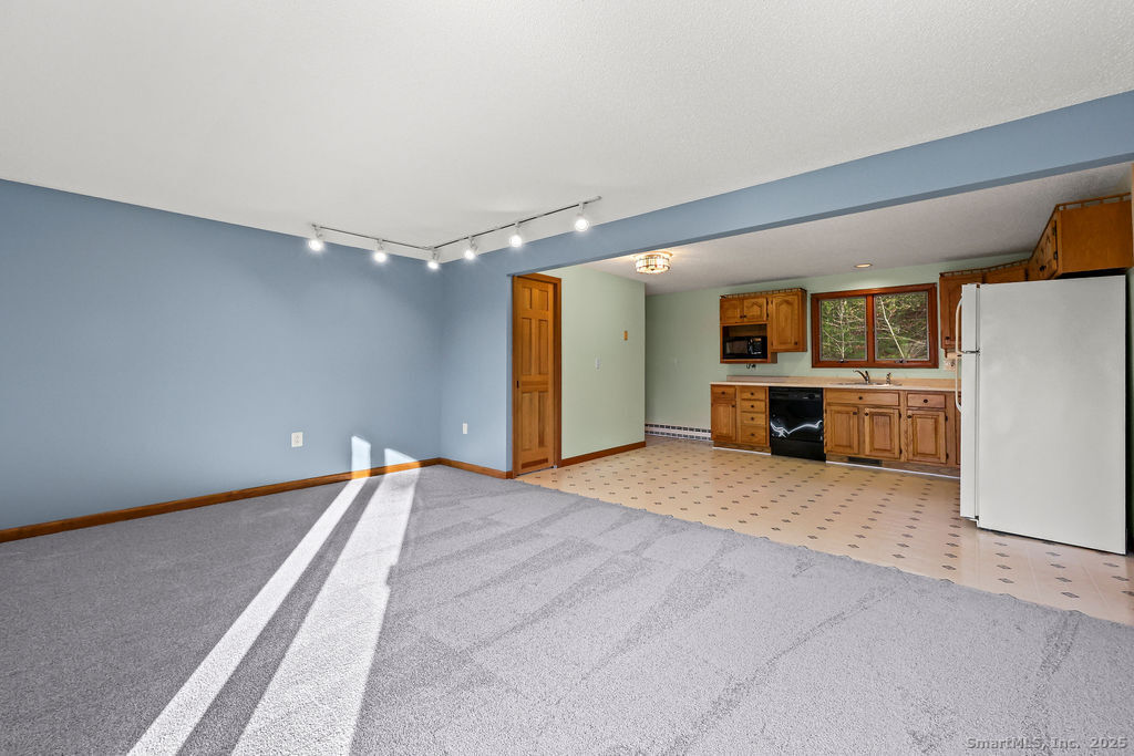 15 Deepwood Road Stafford, CT 06076 - Photo 10 of 30 a view of a kitchen with a sink and a refrigerator