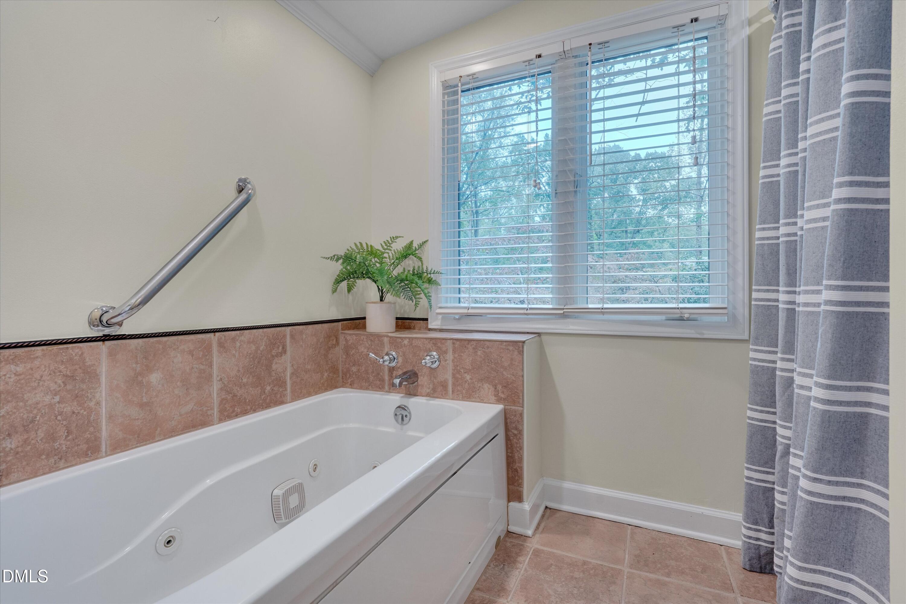 1617 Shawnee Street Durham, NC 27701 - Photo 13 of 56 a bathroom with a bathtub and shower