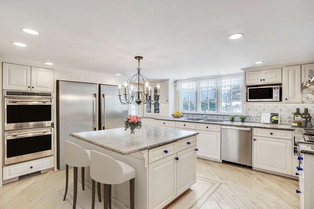 101 Holt Road Andover, MA 01810 - Photo 13 of 38 a kitchen with stainless steel appliances granite countertop a kitchen island hardwood floor sink and stove