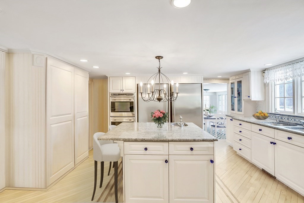 101 Holt Road Andover, MA 01810 - Photo 14 of 38 a large kitchen with granite countertop a sink and white cabinets