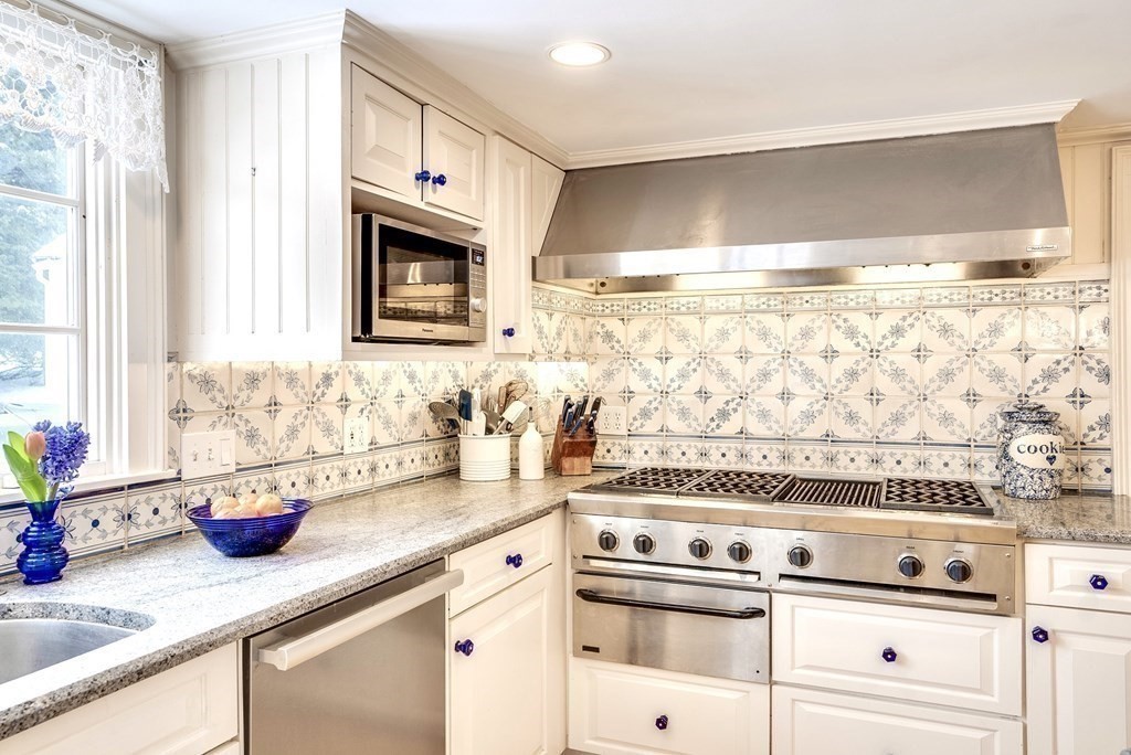 101 Holt Road Andover, MA 01810 - Photo 16 of 38 a kitchen with granite countertop white cabinets and white appliances
