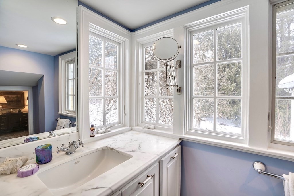 101 Holt Road Andover, MA 01810 - Photo 22 of 38 a bathroom with a granite countertop sink and a large mirror