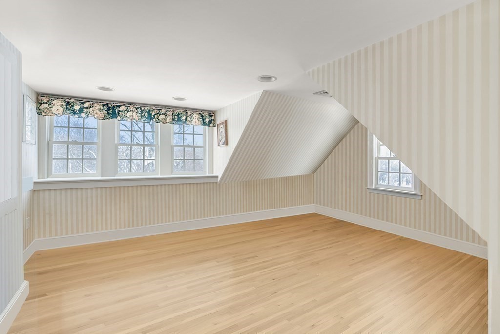 101 Holt Road Andover, MA 01810 - Photo 25 of 38 a view of an empty room with wooden floor and windows