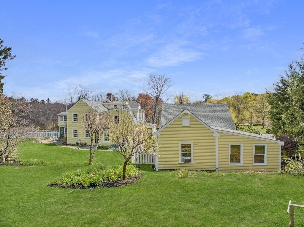 101 Holt Road Andover, MA 01810 - Photo 6 of 38 a view of a house with a big yard potted plants and large tree