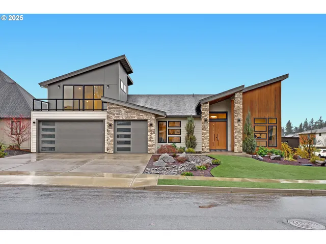 a front view of a house with a yard and garage